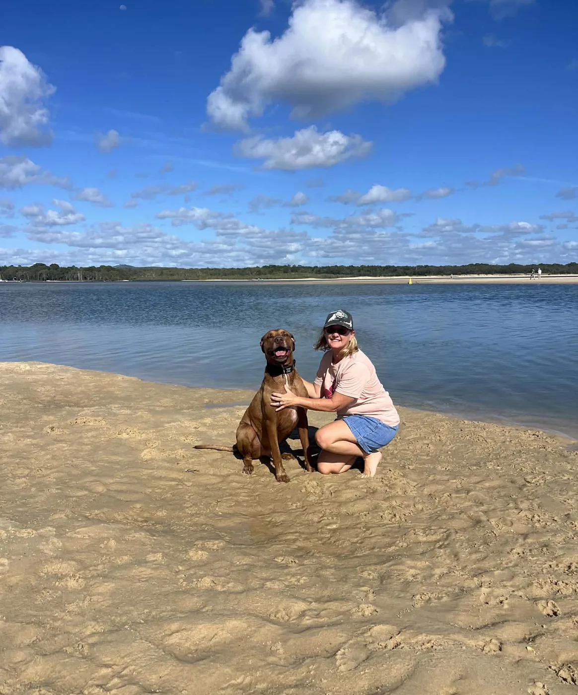 Lisa and a dog at the water's edge