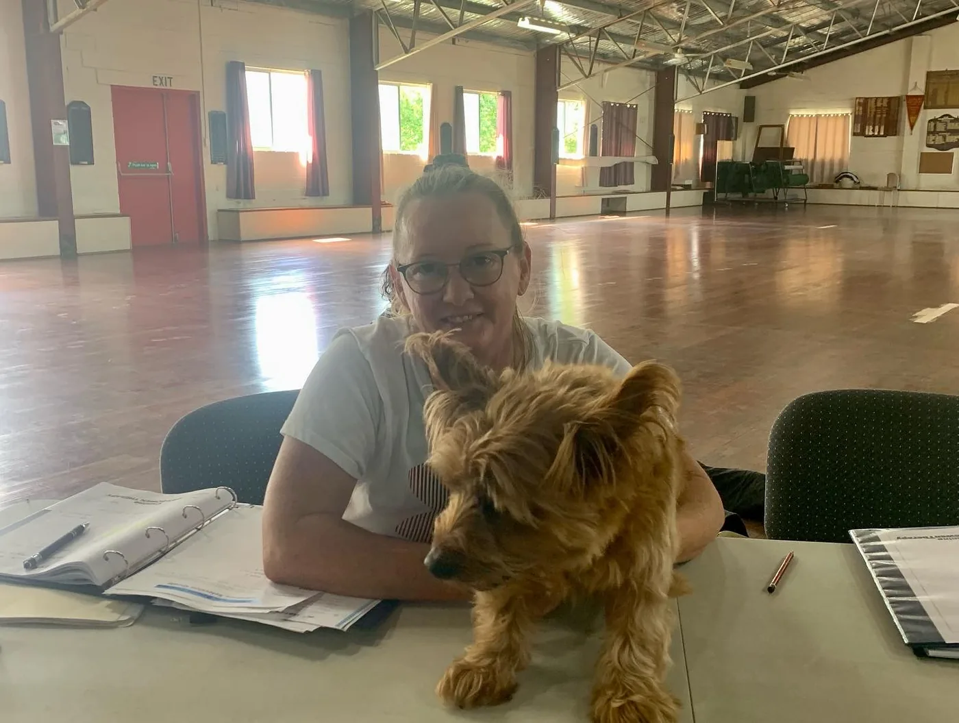 Lisa with a terrier on her lap after a session